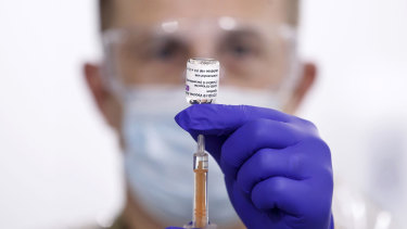 A military medic prepares a dose of coronavirus vaccine in Leeds, England.