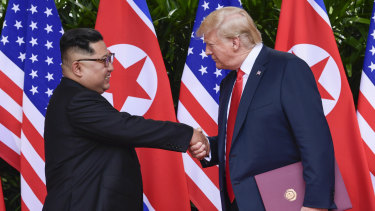"In love": North Korea leader Kim Jong-un and US President Donald Trump shake hands at the conclusion of their meetings in Singapore in June. 