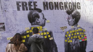 Hundreds of people posted sticky notes in support of Hong Kong pro-democracy protesters over a mural by Chinese-Australian artist and activist Badiucao in Hosier Lane.