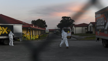 Workers in protective gear at a Melbourne aged care home.