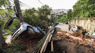 A vehicle lies half-buried in the mud after a landslide caused by heavy rains in Belo Horizonte, Brazil. 