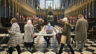 People arrive to receive their COVID-19 vaccine in Westminster Abbey, London. 