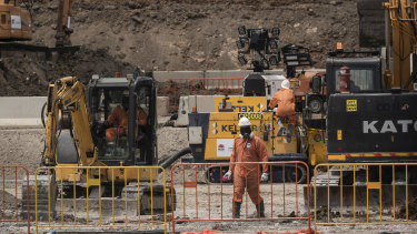 Workers in protective gear at 6 Grand Avenue in Camellia, which is a heavily contaminated site that will become the main stabling yard for trams.