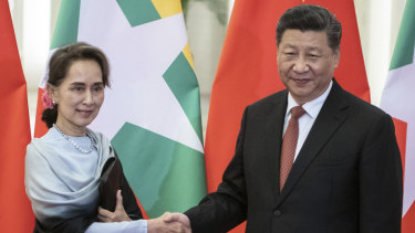 Chinese President Xi Jinping, right, shakes hands with then-Myanmar State Counsellor Aung San Suu Kyi n 2019 in Beijing.