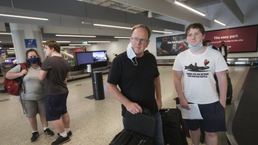 David Duncan with his son at Melbourne Airport on Friday morning. 