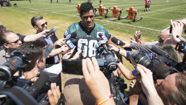 Centre of attention: Jordan Mailata is tackled by a media scrum after making the Eagles' final roster.