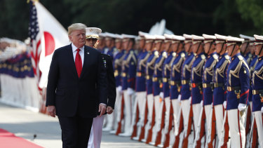 US President Donald Trump inspects an honour guard during a welcome ceremony at the Imperial Palace in Tokyo, Japan, on Monday.