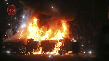 A car burns after petrol bombs were thrown at police in Creggan, Londonderry.