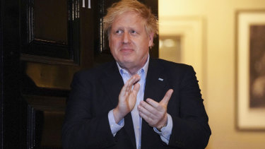 Prime Minister Boris Johnson claps outside 11 Downing Street to salute local heroes during Thursday's nationwide Clap for Carers NHS initiative. Johnson is living at No 11 in isolation after being diagnosed with COVID-19.