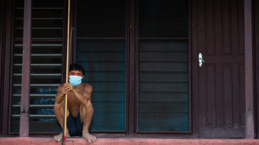 A Yanomami man awaits medical attention during the coronavirus pandemic in Alto Alegre, Roraima, Brazil. Indigenous representatives say 405 tribespeople have died of COVID-19 int he Amazon, and more than 9000 have been infected.