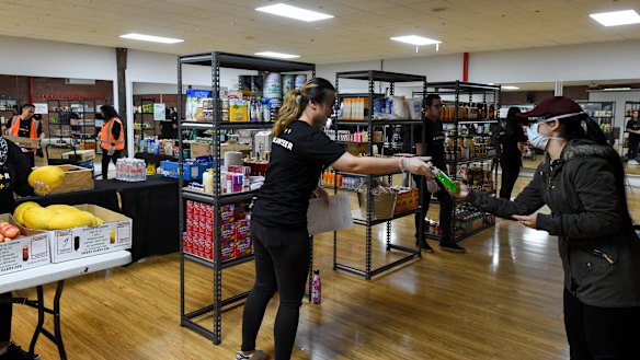 Volunteers hand out groceries at Planetshakers church's relief centre in Southbank.