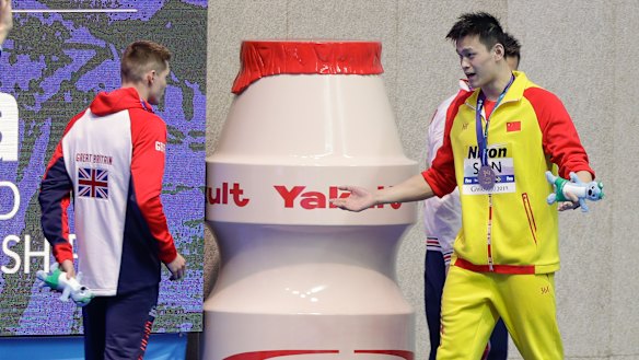 "I win, you lose": Gold medalist China's Sun Yang, right, gestures to Britain's bronze medalist Duncan Scott.