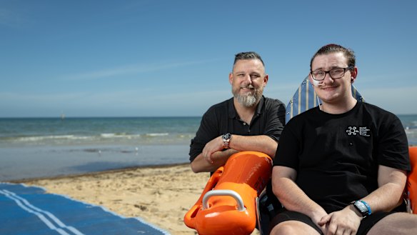 Frankston local Kayden Crombie and Frankston Councillor Nathan Butler at Frankston beach. Kayden is in one of the beach accessible wheelchairs that will form part of a new initiative to make Frankston beach more inclusive. 