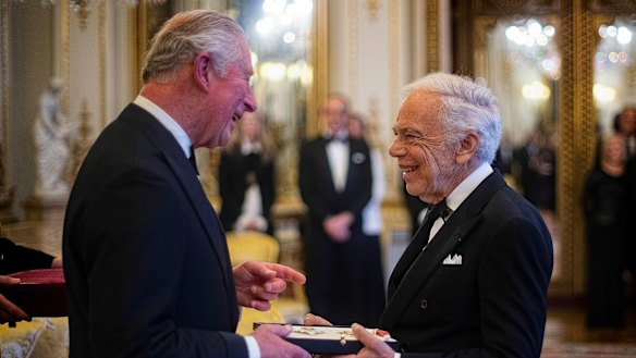 The Prince of Wales presents designer Ralph Lauren with his honorary KBE for Services to Fashion in a private ceremony at Buckingham Palace on Wednesday.