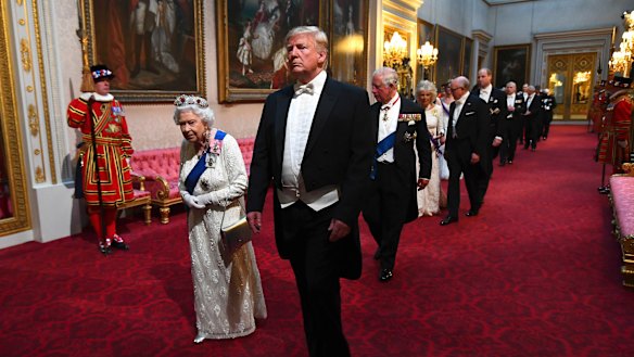 The Queent and US President Donald Trump lead guests through the East Gallery ahead of the State Banquet at Buckingham Palace in London.