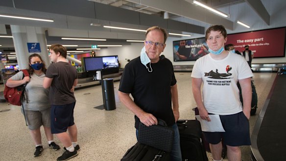 David Duncan with his son at Melbourne Airport on Friday morning. 