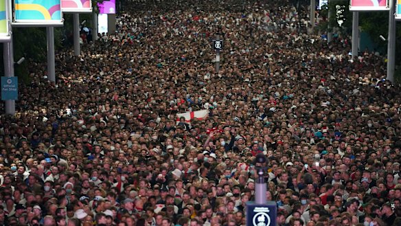 Fans celebrate outside Wembley Stadium after England qualified for the Euro 2020 final.