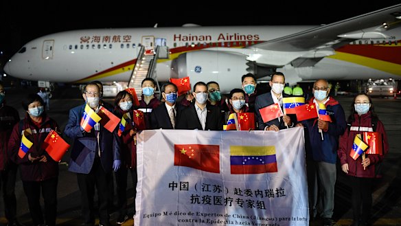 Venezuelan and Chinese officials repeat the PR exercise as a medical team arrives from China in La Guaira, Venezuela.