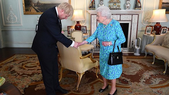 It was soon hot in London this week, a modern portable air-conditioning tower can be seen among the period decoration of Buckingham Palace reception room where the Queen invited Boris Johnson to become prime minister.