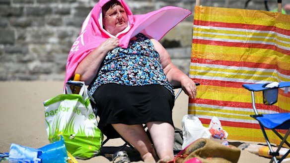 A woman enjoys the sun at Barry Island, south Wales, in late June.