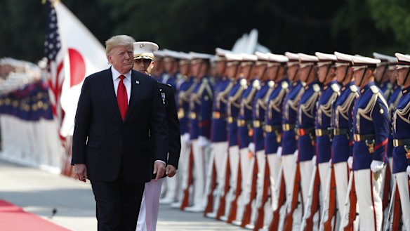 US President Donald Trump inspects an honour guard during a welcome ceremony at the Imperial Palace in Tokyo, Japan, on Monday.