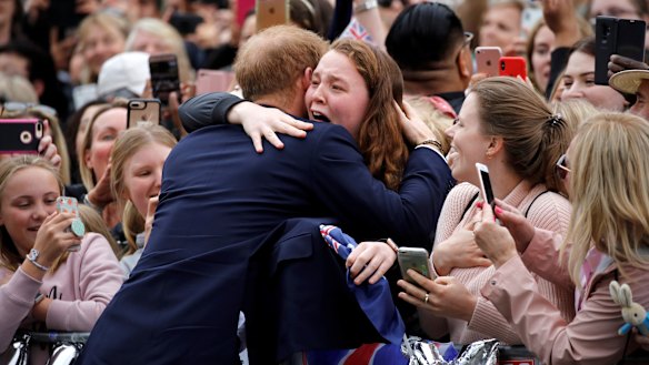 Prince Harry hugs India Brown.