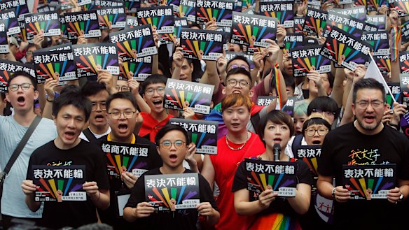 Same-sex marriage supporters gather outside the Legislative Yuan in Taipei for the decision.