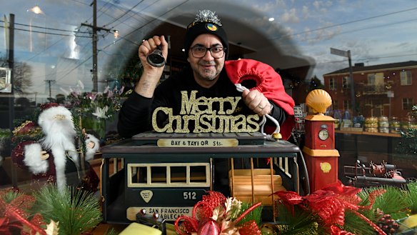 Danny Harb, owner of St Derby's cafe in Pascoe Vale with their Christmas in July window display that they hope will cheer up locals during the second lockdown.