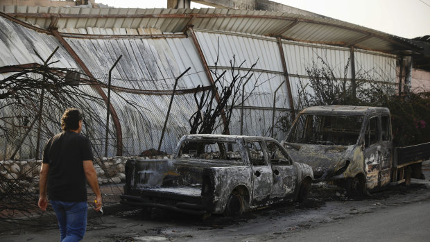 Burnt cars sit in Sderot, southern Israel, after Tuesday's rocket firing from Gaza.