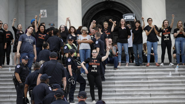 Demonstrators opposed to Supreme Court nominee Brett Kavanaugh are detained by US Capitol police.