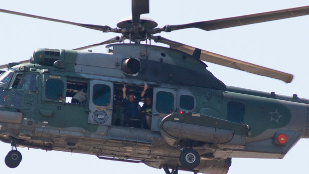 President Jair Bolsonaro waves at supporters from a helicopter in Brasilia, Brazil. 