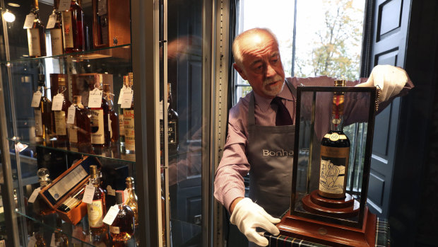 Danny McIlwraith from Bonhams auction house holds bottle of the world's rarest and most valuable whisky, The Macallan Valerio Adami, at the Bonhams Whisky Sale at their Edinburgh auction house.