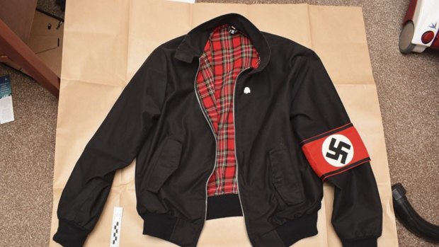 A jacket bearing a Swastika armband found during police searches of Adam Thomas and Claudia Patatas' home.  
