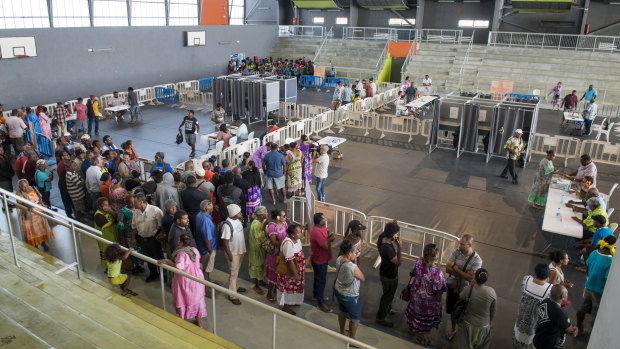 Residents of New Caledonia's capital, Noumea, wait in line to cast their vote in the independence referendum.