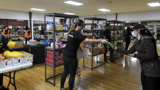 Volunteers hand out groceries at Planetshakers church's relief centre in Southbank.