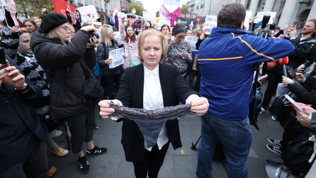 Irish politician Ruth Coppinger holds a pair of underwear during a protest in support of victims of sexual violence in Dublin on Wednesday November 14, 2018. 