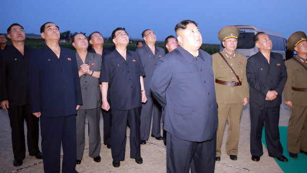 In this August 6, 2019 photo provided by the North Korean government, Kim Jong-un visits an airfield in the western area of North Korea to watch its weapons demonstrations.