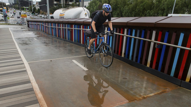 Brown sediment lies on a bike path.