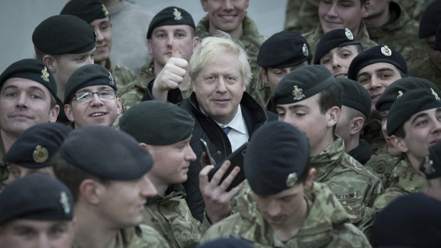 Britain's Prime Minister Boris Johnson addresses British soldiers after serving Christmas lunch to troops stationed in Estonia. He will lead the UK out of the EU this year.