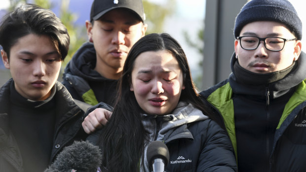 Trish Nguyen, Thomas Tran's girlfriend, was supported by friends at the scene on Tuesday morning.