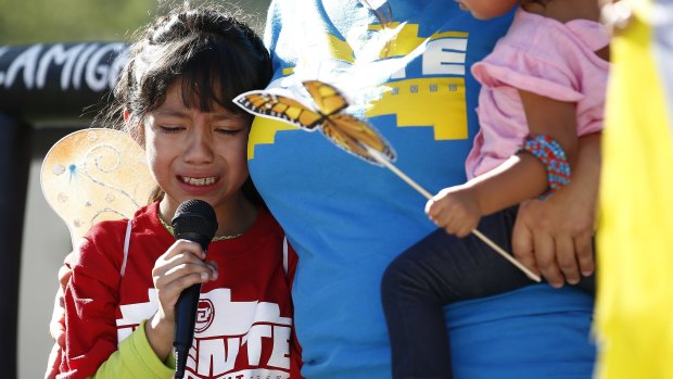 Akemi Vargas, 8, cries as she talks about being separated from her father.