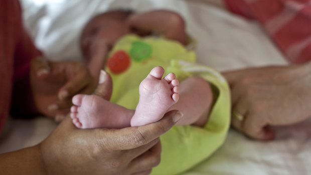 A British couple's baby born to a surrogate mother in Anan, India.