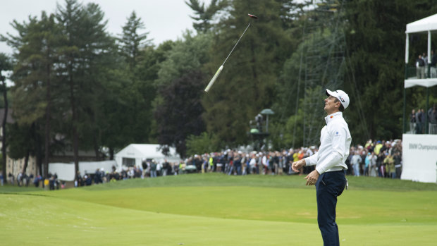 Frustration: Justin Rose tosses his club after missing a putt for par on the 18th hole.