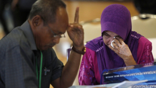 A relative of passengers on board the missing Malaysia Airlines Flight 370 reacts as she arrives for MH370 safety investigation report briefing at ministry of transportation in Putrajaya, Malaysia on Monday.