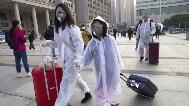 Travellers at Wuhan's main train station on Wednesday, the day the lockdown was partially lifted. Beijing will not countenance any criticism of how it managed the virus outbreak.