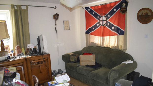 Swastika cushions and a Ku Klux Klan flag hanging in the lounge of the home of Adam Thomas and Claudia Patatas.  