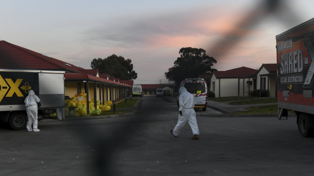 Workers in protective gear at a Melbourne aged care home.