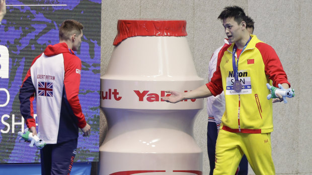 "I win, you lose": Gold medalist China's Sun Yang, right, gestures to Britain's bronze medalist Duncan Scott.