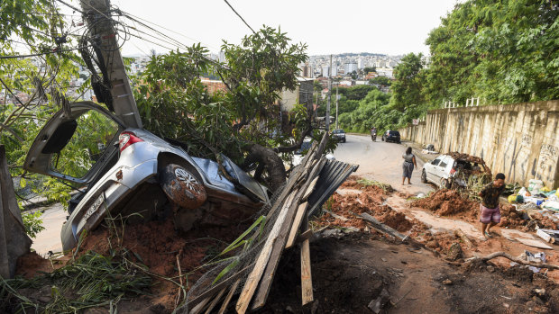 A vehicle lies half-buried in the mud after a landslide caused by heavy rains in Belo Horizonte, Brazil. 