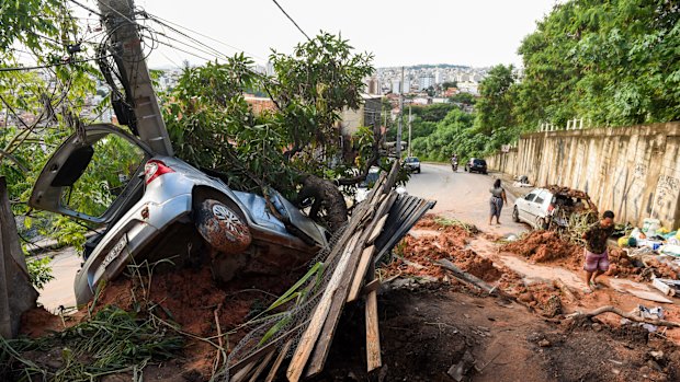 A vehicle lies half-buried in the mud after a landslide caused by heavy rains in Belo Horizonte, Brazil. 